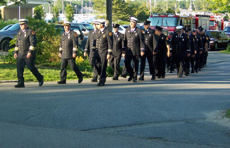 Outgoing Fire Chief Tom Joyce leads department members into the Music Hall for the ceremony. BY MATTHEW BERNAT
